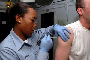  Hospital Corpsman 3rd Class Natasha Wooden administers a Hepatitis-B vaccine to a Sailors aboard the Nimitz class aircraft carrier USS Ronald Reagan (CVN 76). Reagan is currently underway conducting routine carrier operations